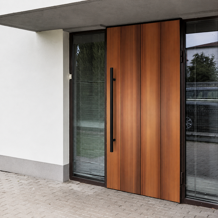 A black round door handle installed in a brown door