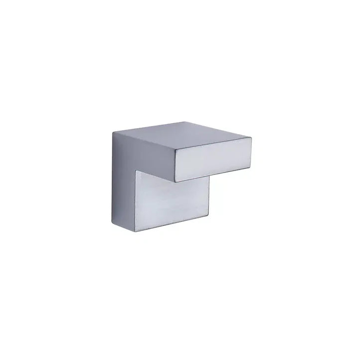 A modern Taymor Industries cabinet or drawer knob with a geometric, angular design, featuring a rectangular top and perpendicular base. Made from durable Zinc Die-Cast, it measures 1 inch in width and is shown against a plain white background.