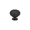 A matte black round cabinet knob by Taymor Industries, featuring a smooth dome top, short cylindrical base, modern design, and sturdy zinc die-cast construction, is centered on a plain white background.